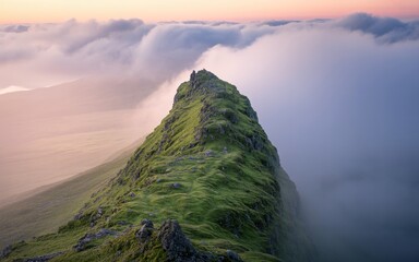 Majestic Mountain Peak Pierces Through a Sea of Clouds at Dawn