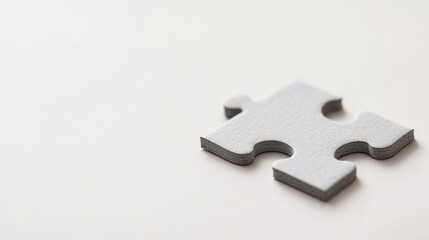 Obraz premium Minimalist puzzle piece lying flat on a tabletop in a serene studio