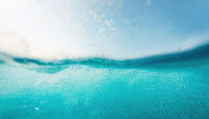 underwater view of clear turquoise ocean surface with rising bubbles and sunlit waves for aquatic branding, wellness design, or marine inspired background

