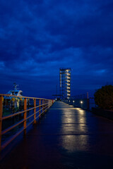 Fototapeta premium Illuminated Observation Tower on the Friedrichshafen Pier at Dusk