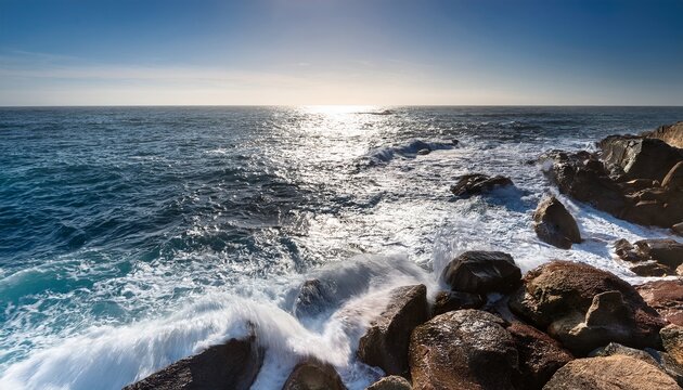 rocky shoreline with foamy waves and sparkling water
