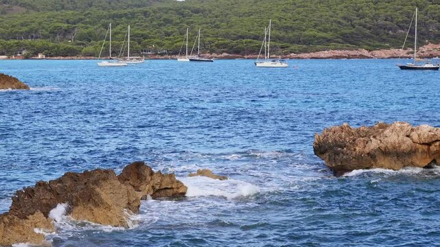 Sailing boats anchored in front of Cala Agulla beach in Mallorca