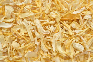Fototapeta premium Organic Dried Jackfruit Slices on White Background. High-resolution image of organic dried jackfruit slices in a bowl, with scattered pieces on a clean white background.