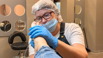 A skilled Caucasian female podiatrist attentively performs meticulous foot care, celebrating World...