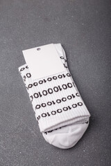 Funny odd socks for geek, developer or programmer with binary 01 code and blank label on grey...