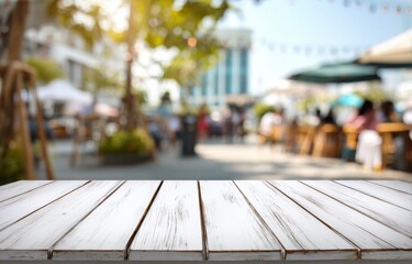 White wooden table with blurred outdoor cafe background