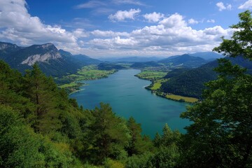 Verdant mountains enclose a tranquil lake beneath a cloudy blue sky