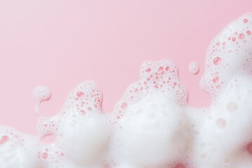 Beauty Product Foam Soap. Abstract background white soapy foam flowing texture. Shampoo foam with bubbles. Bubble surface isolated on pastel pink coral rose color. Suds. Facial cleanser. Froth Pattern