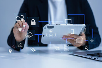 Person using smartphone, tablet with SDK icon on virtual screen. SDK Software development kit programming language technology concept in office.