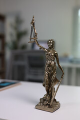 Lady Justice, a symbol of impartiality and fairness in the legal system, is holding scales and a...