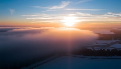 Fototapeta premium Sunrise Over the Clouds: Aerial view of a stunning sunrise over the clouds, with the sun shining brightly and the clouds lit up with colors. 