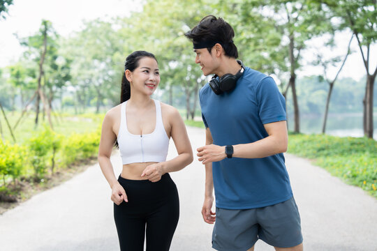 Athletic couple enjoys a refreshing run together in the park embracing fitness and togetherness - Powered by Adobe