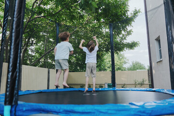 Kids jumping on a trampoline, experiencing pure joy and excitement. Bright and cheerful outdoor...