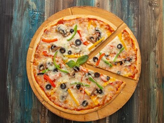 Delicious Thin Crust Chicken Pizza with Olives and Bell Peppers on Wooden Board – Overhead View
