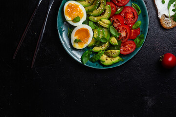 Healthy Breakfast with Avocado, Egg, and Tomato on a Plate