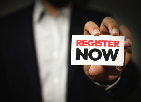 Register Now typography shown by the person with card in hand close up shot.  Online registration concept