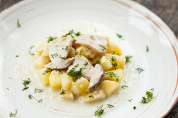 Potatoes with porcini mushrooms and dill on a plate