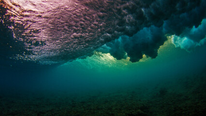 Underwater view of the ocean wave breaking over the shore in the Maldives