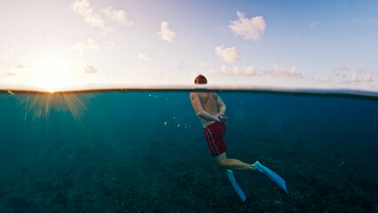 Man swims in the sea with breaking waves. Splitted shot of the male swimming in the ocean on a surfing spot