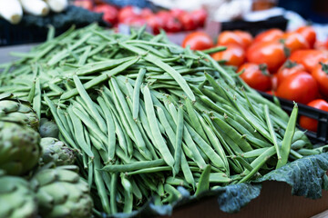 Fresh green beans on display at a farmers market, showcasing the abundance of summer harvest
