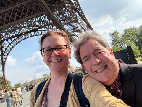 Smiling Couple Taking a Selfie at Iconic Eiffel Tour Landmark