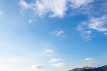 nature backdrop with blue sky and white fluffy clouds in morning light. bright and sunny weather forecast background