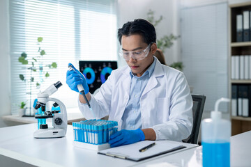 A man in a lab coat is working with a microscope