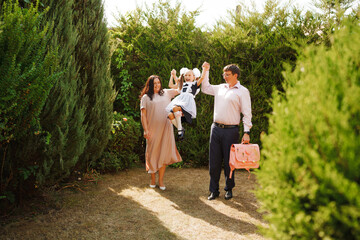 A family in the garden sees off daughter on first day of school