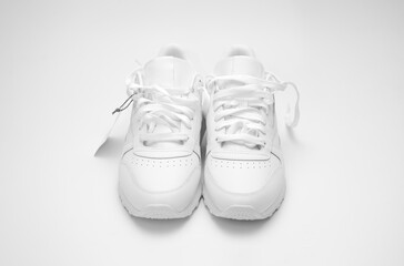 New white sneakers on a white background.