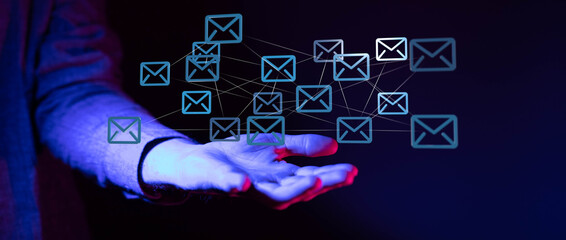 Abstract image of interconnected emails above a hand, symbolizing global communication and networking.