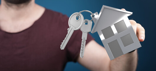 Image of a person holding house keys, symbolizing homeownership, real estate, and new beginnings.