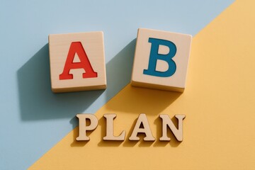 Colorful Alphabet Blocks Forming a Simple Plan Concept on Pastel Background