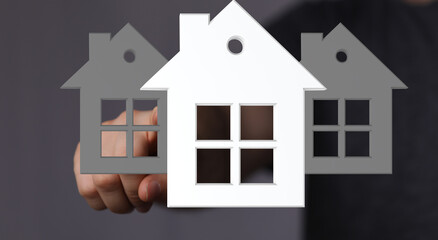 Person chooses a house, real estate, home buying, property selection, new home.