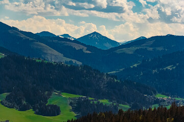 Alpine spring view with distant peaks in the background seen from Wochenbrunner Alm, Ellmau,...