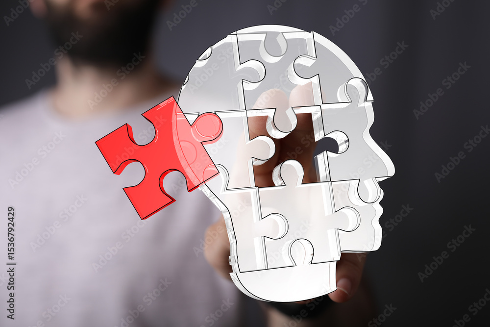 Poster Unlocking potential.  A hand places a puzzle piece into a human brain, symbolizing problem-solving and cognitive function.