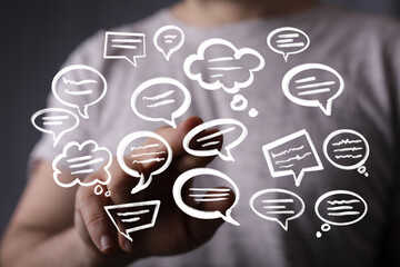 Abstract image of a person interacting with digital speech bubbles, representing communication and...