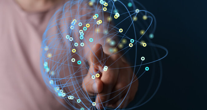 Abstract image of a hand interacting with a digital network.  Concept for technology, connection, and global communication.