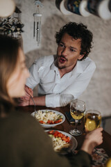 Two friends having a casual dinner together, engaging in lively conversation and enjoying good food. The cozy indoor setting creates a warm and inviting atmosphere.