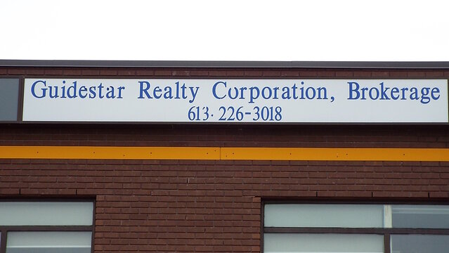 Nepean, ON, Canada-June 14,2025: A white sign with "Guidestar Realty Corporation, Brokerage" at 1400 Clyde Avenue.  
