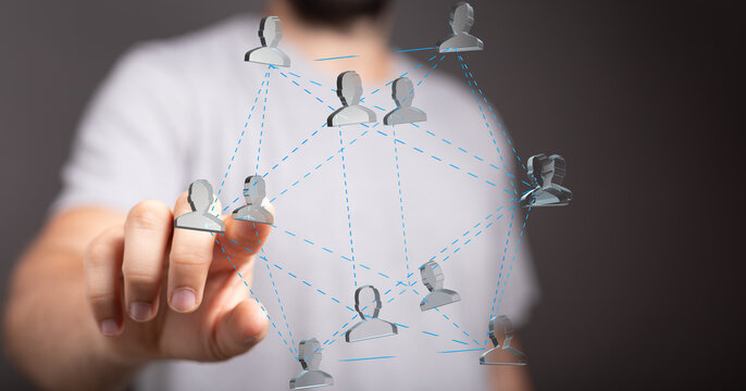 Man interacts with a digital network of people, symbolizing connections and collaboration. - Powered by Adobe