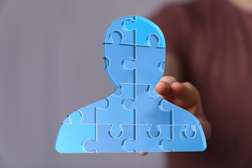 Abstract image of a person made of puzzle pieces. Teamwork, collaboration, unity.