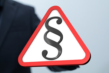 Stock photo of a red triangle warning sign with a paragraph symbol, representing legal issues or...