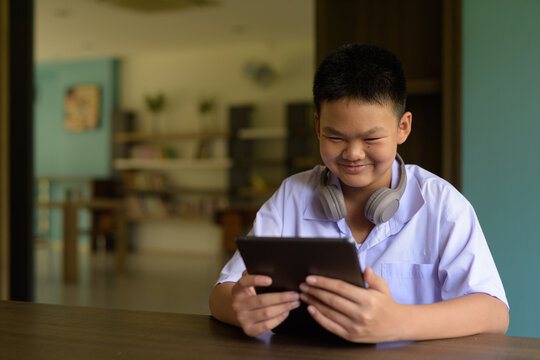 Thai Student in School Uniform Studying in Library