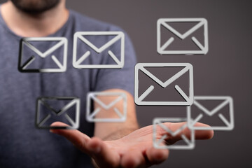 A man's hand displays multiple email icons, symbolizing efficient inbox management and...