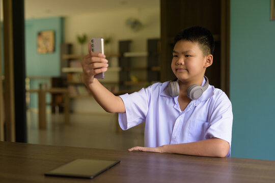 Thai Student in School Uniform Studying in Library