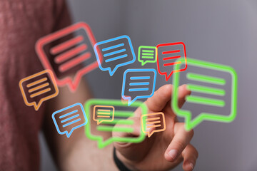 Image of a person interacting with colorful chat bubbles, symbolizing communication and connection.
