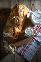 Fresh white bread and milk on a village table