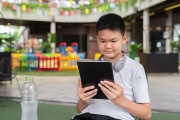 Young teenager student boy using digital tablet computer