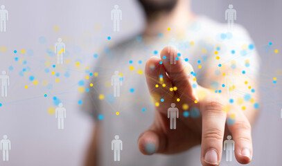Image depicts a hand interacting with a digital network of interconnected people, symbolizing...