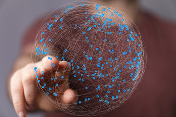 Abstract image of a hand interacting with a digital sphere representing global networking and...
